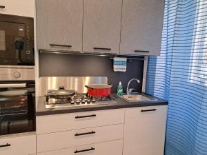 a kitchen with a stove with a pot on it at I Catusi GuestHouse in Santo Stefano di Camastra