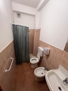 a bathroom with a toilet and a sink at Ostello Paradiso EuroCamp in Cesenatico