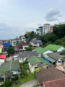 a group of houses with green roofs in a city at 07 Antalya Boutique Hotel in Patong Beach
