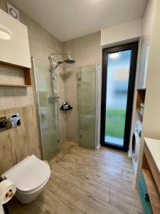 a bathroom with a shower and a toilet at Domki Na Łące in Święta Katarzyna +14 photos