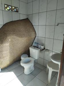 a bathroom with a toilet and a sink at Chale Tupi in Trindade
