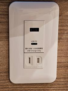 a white electrical outlet on a wooden table at Asakusa Stay in Tokyo