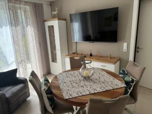 a living room with a table and a tv at Ferienwohnung Isenberg in Bad Reichenhall