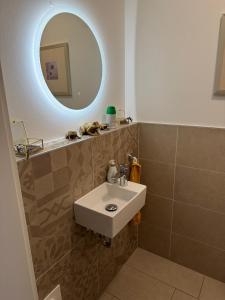 a bathroom with a sink and a mirror at Ferienwohnung Isenberg in Bad Reichenhall +8 photos