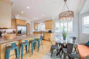 a kitchen with a bar with chairs and a table at Coastal Dream - 2 Blocks to ocean, steps to beach, hot tub, coastal trail, BBQ in Half Moon Bay