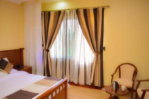 Cama ou camas em um quarto em Red Ruby Hotel