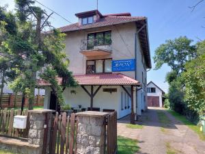 a house with a fence in front of it at Baltic in Łeba