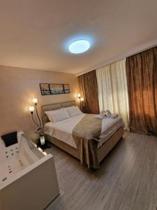 a bedroom with a bed and a bath tub in it at All In Jacuzzi Apartment in Petroşani +19 photos