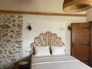 a bedroom with a bed with a wooden headboard at Villa Noble in Faralya