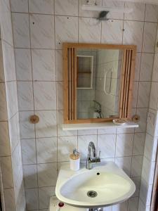 a bathroom with a sink and a mirror at Ferienwohnung Sonneninsel in Ostseebad Sellin +23 photos