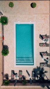 a wall with a swimming pool next to a building at Villa Bell Lloc by SOMNIA in Felanitx