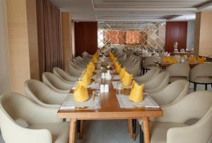 a long table in a restaurant with white chairs at Nagarjun Resort - Embrace Tranquility Natures Retreat Beyond the City in Kathmandu