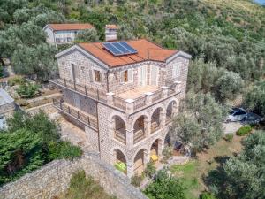 an aerial view of a house with a solar roof at Villa Olive Grove in Budva