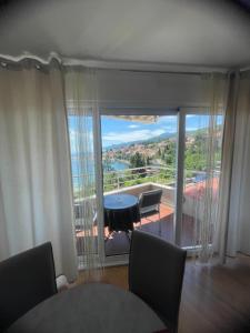 a room with a balcony with a table and chairs at Apartments Villa Dinka in Opatija