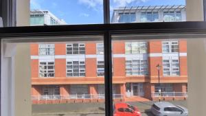 a view of a building from a window at Birmingham City Stays Apartments in Birmingham