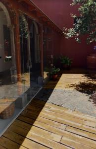 a wooden walkway in front of a building at La Colonial in Vega de San Mateo