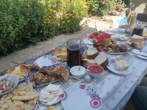 a table topped with plates of food and a drink at GoGni OLD ROOM in Gogni