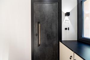 a black door in a kitchen with a counter at Luxury - Le petit Bati in Volos +70 photos