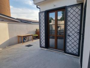 an open patio door with a table on a balcony at Red Rose Tiburtina in Rome