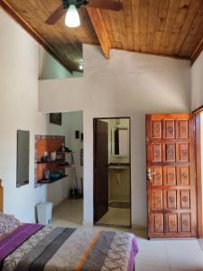 a bedroom with a bed and a wooden ceiling at Recanto Videira Rota do Vinho in São Roque