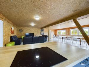 a living room with a table and chairs and a couch at Gîte mon papi - 18 personnes in Méry-sur-Seine