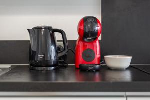 a red appliance sitting on top of a kitchen counter at L'Ambre - T2 Lumineux - Parking, RER A, Disneyland in Montévrain