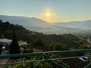a view of the sun setting over a city at Relax Camping in Gjirokastër