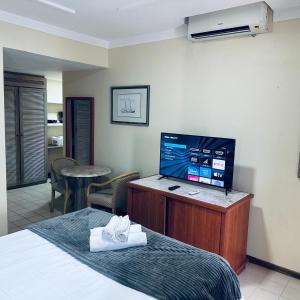 a hotel room with a bed and a flat screen tv at Flat 10 andar Hotel Costa Mar acesso direto praia in Recife +18 photos