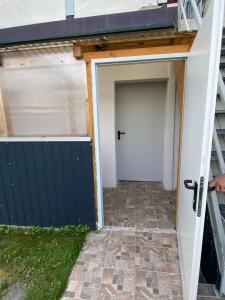 a garage with a white door and a gate at Marija Apartment in Lustenau