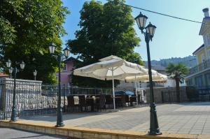 un semáforo con sombrilla, mesas y sillas en Gostinstvo Tomex, en Ilirska Bistrica