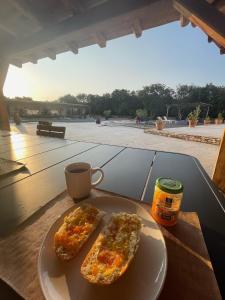 two slices of pizza on a plate on a table with a cup of coffee at Casa Canetto, vous y êtes déjà! 14 personnes in Bonifacio