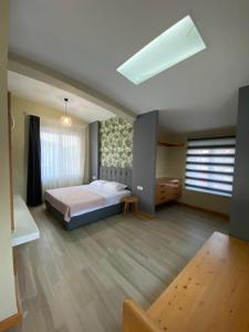 a large bedroom with a bed and a window at Happy Land Belek in Belek