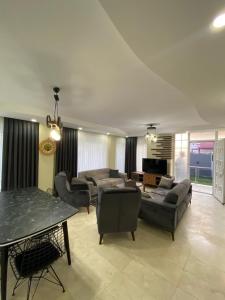 a large living room with couches and a table at Happy Land Belek in Belek +7 photos