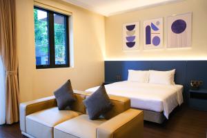 a hotel room with a bed and a couch at Indigen Riverside Hotel Cao Bang in Cao Bằng +43 photos