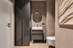 a bathroom with a sink and a mirror at Scala 3 by Grand Apartments in Gdańsk +11 photos