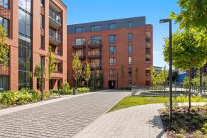 a brick building with a brick sidewalk in front at Scala 3 by Grand Apartments in Gdańsk