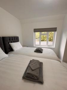 a bedroom with a bed with a towel on it at Mote Park View in Kent