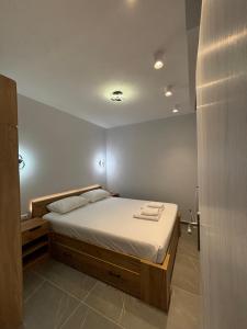 a bedroom with a large bed with towels on it at Manis apartment in Prinos