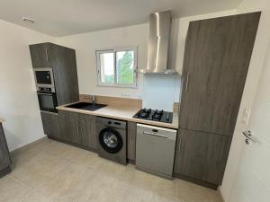a kitchen with a stove and a dishwasher in it at La Gourgotte in Ajac +8 photos