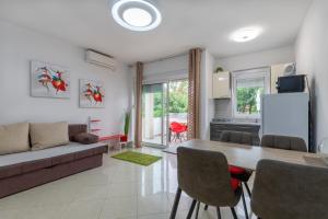 a living room with a table and a couch at M&B Green Oasis with pool and jacuzzi in Bibinje