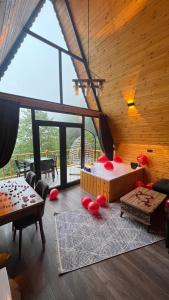 a room with a bed with red pillows on it at AĞARAN Wooden Houses 2 in Cayeli