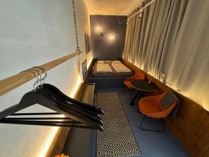 a small room with two beds and a window at Bratislava center - blue apartment in Bratislava