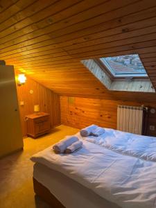 a bedroom with a bed with two towels on it at Apartments FAMILY & FRIENDS -free parking in Sarajevo