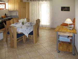 a kitchen with a table with chairs and a dining room at Holiday Home Yellowhouse in Kaštel