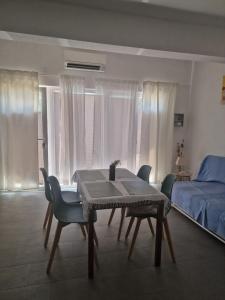 a room with a table and chairs and a bed at Obala 111 in Poljica