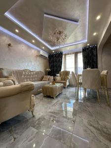 a large living room with couches and a chandelier at AR Luxury VIP Apartments Ravda in Ravda