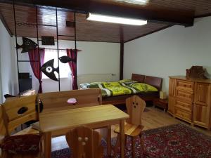 a bedroom with a bed and a table and chairs at Apartmán pri vinotéke in Kežmarok