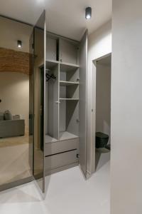 a walk in closet with a glass door at Biagio Boutique Studio - in Old Town - Ultra Central in Braşov