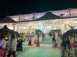 a group of people standing outside of a market at night at Twoja Przystań SŁAWA- Apartament przy plaży in Sława +23 photos