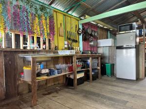 a kitchen with a counter and a refrigerator at Iguana Azul Pacific Paradise in Buenaventura
